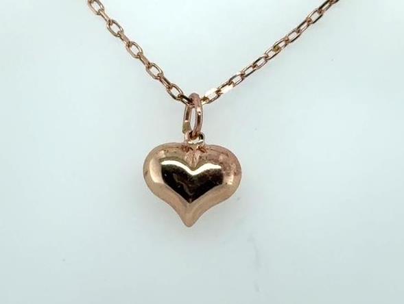 Petite puffed heart pendant in polished rose gold tone on a rolo chain.