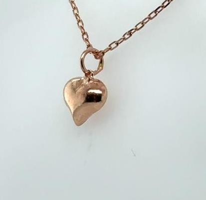 Petite puffed heart pendant in polished rose gold on a delicate rolo chain.