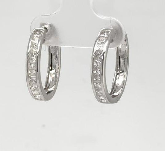 White gold hoop earrings with channel-set princess-cut diamonds along the front.