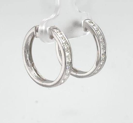 14K white gold hoop earrings with channel-set princess-cut diamonds along fronts.