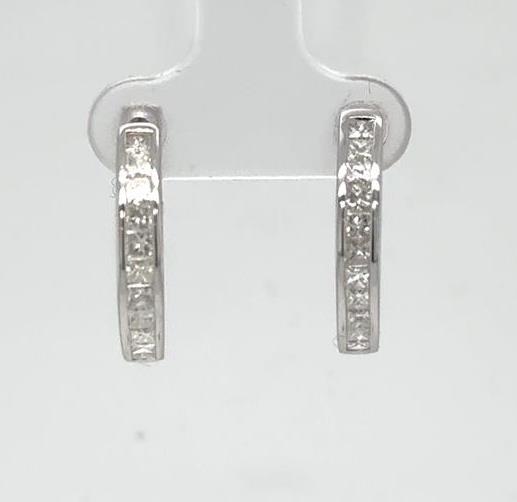 14K white gold small hoop earrings with channel-set princess-cut diamonds.