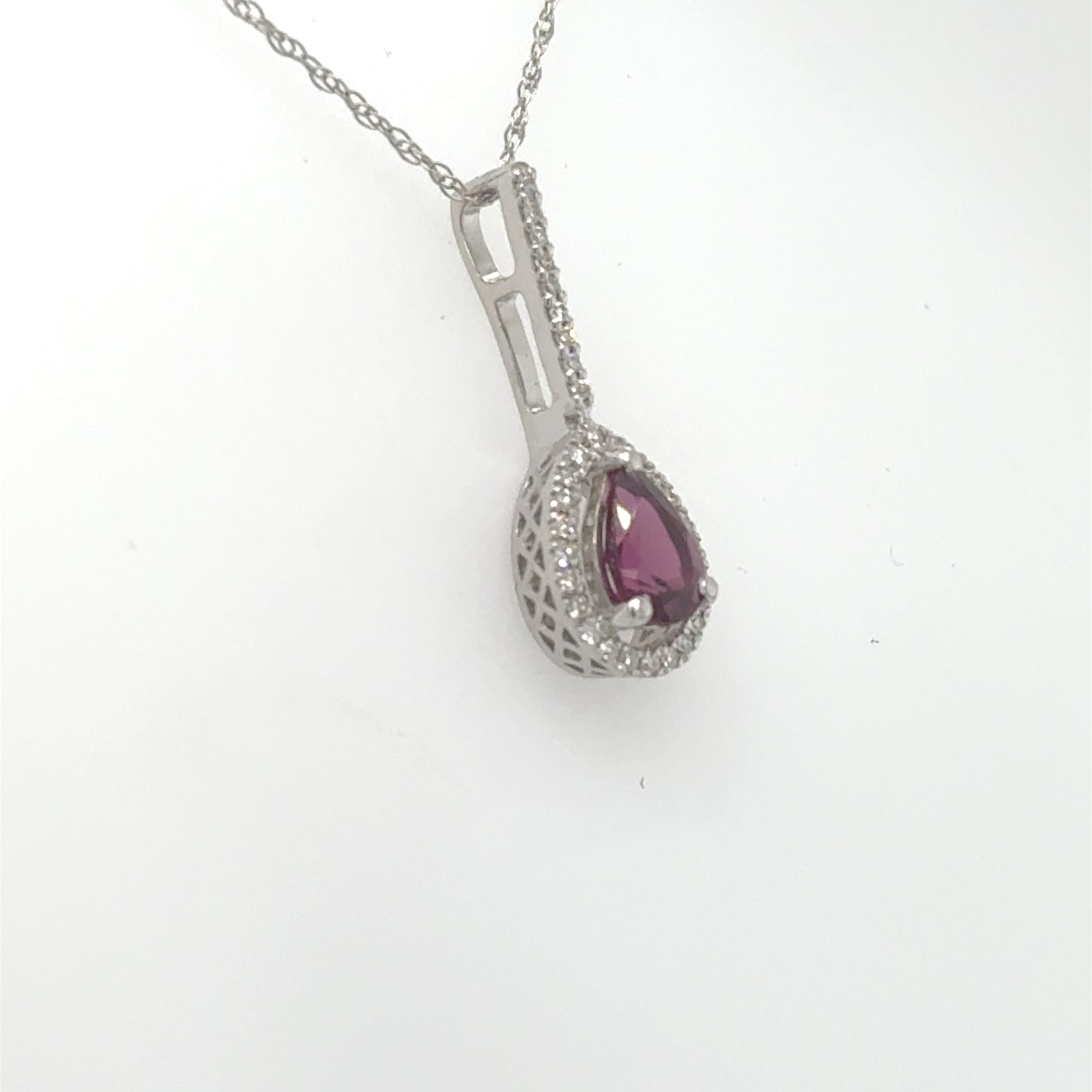 14K white gold pendant with pear-shaped rhodolite garnet and diamond halo.