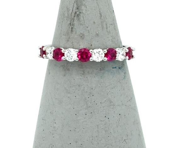 14K white gold band with alternating round rubies and diamonds in shared prongs.