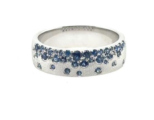 14K white gold band with scattered round blue sapphires burnish-set throughout.