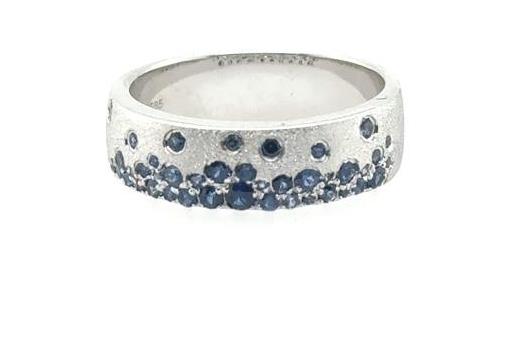14K white gold band with scattered round blue sapphires in a confetti pattern.