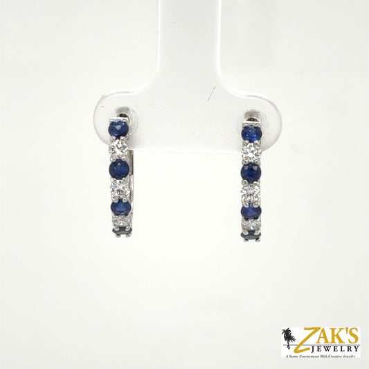 14K white gold small hoop earrings with alternating round blue sapphires and diamonds.