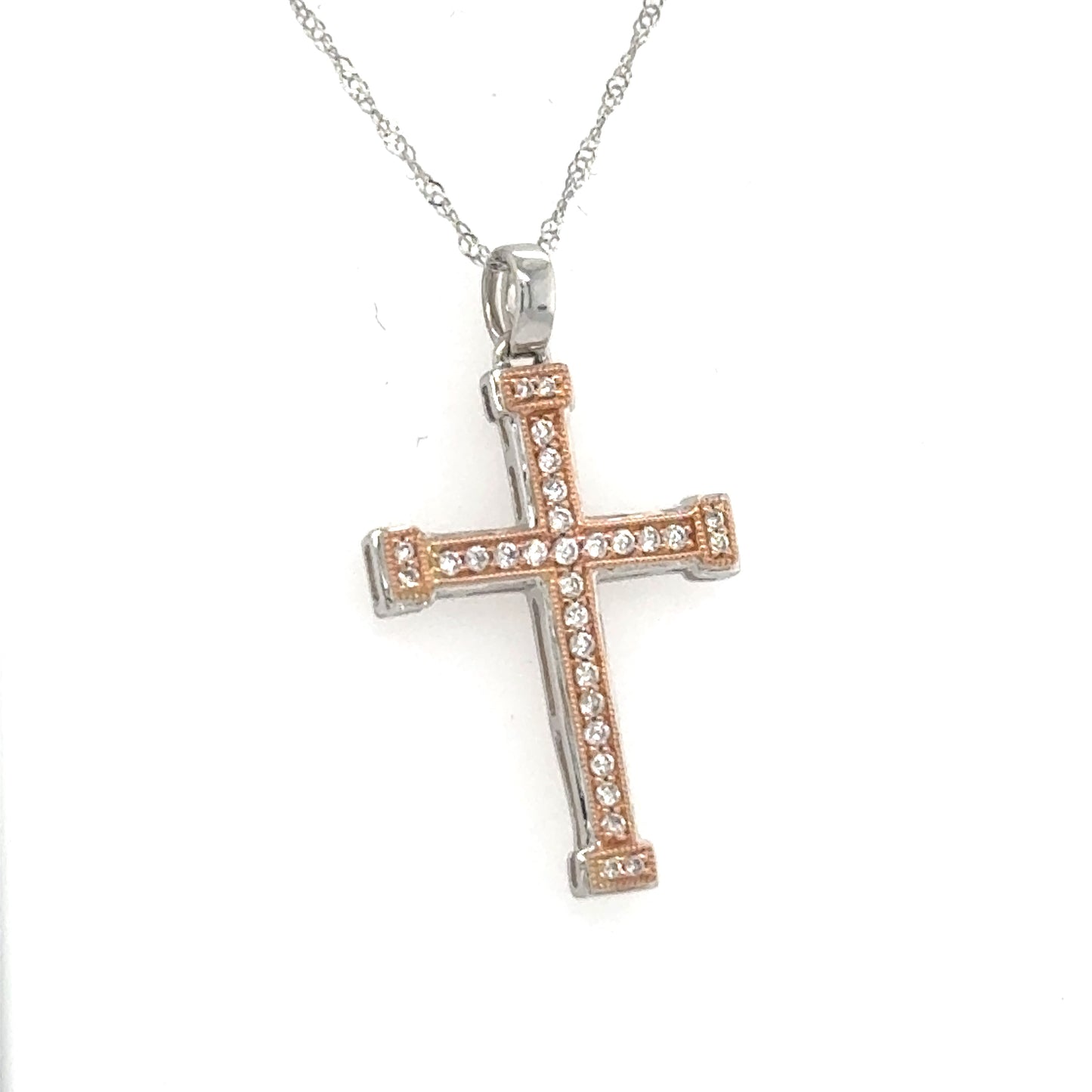 Two-tone white and rose gold diamond cross pendant on an 18-inch rope chain.