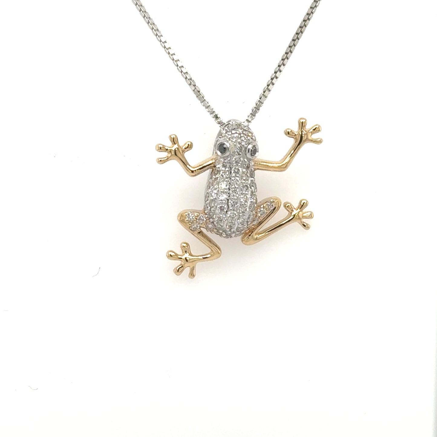14K white and yellow gold frog pendant with pavé diamonds and blue sapphire eyes.