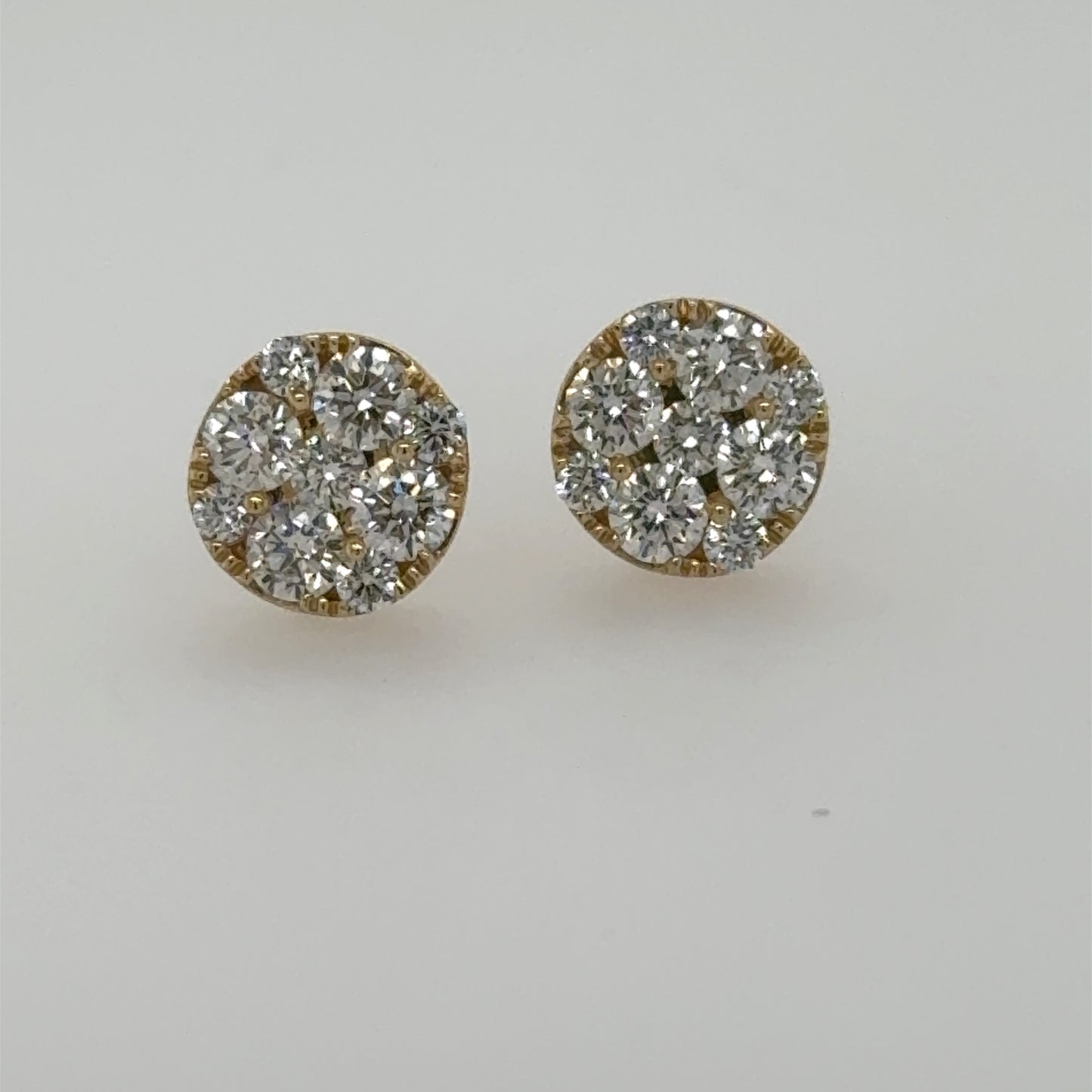Round 14K yellow gold stud earrings with prong-set diamond cluster fronts.