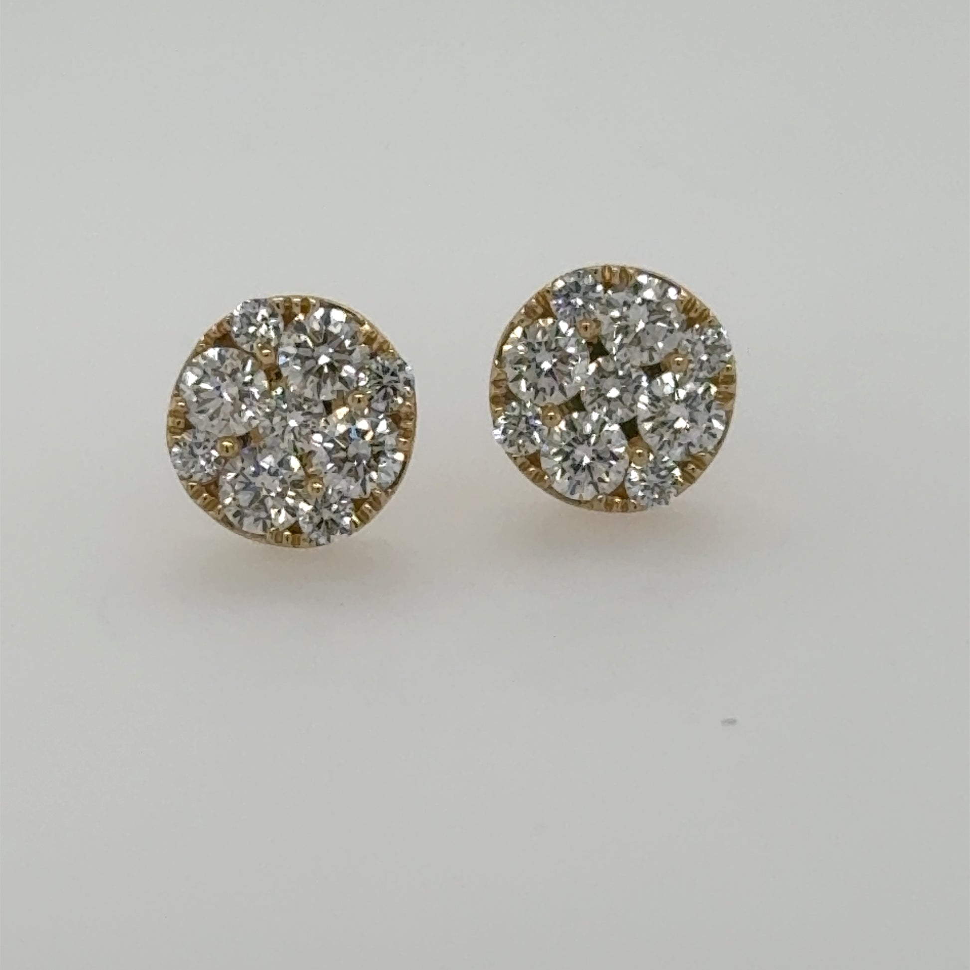 Round 14K yellow gold stud earrings with prong-set diamond cluster fronts.