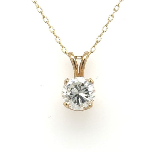 Yellow gold solitaire pendant with round brilliant diamond in four-prong basket and rabbit-ear bail.