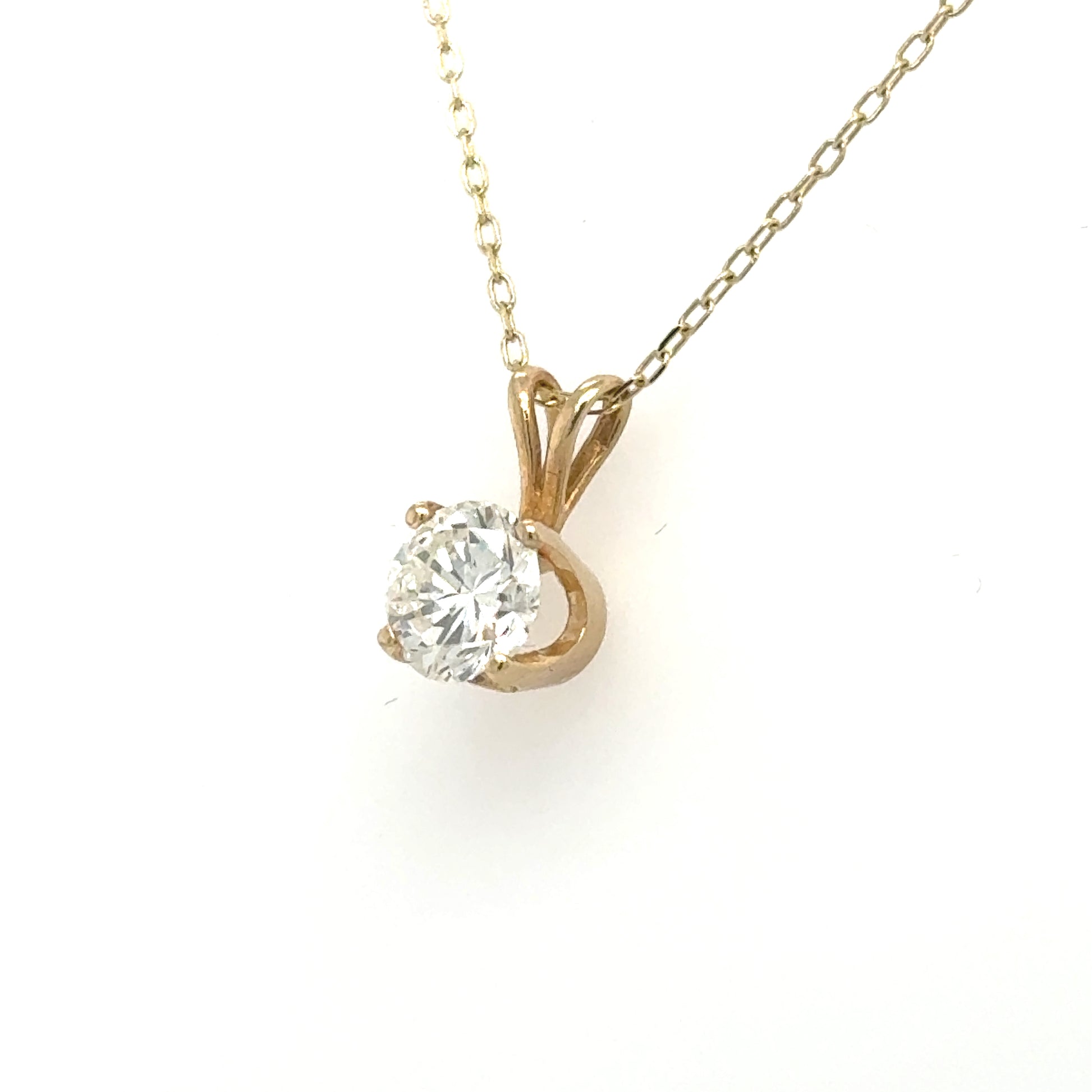 14K yellow gold pendant with round solitaire diamond in four-prong basket and rabbit-ear bail.