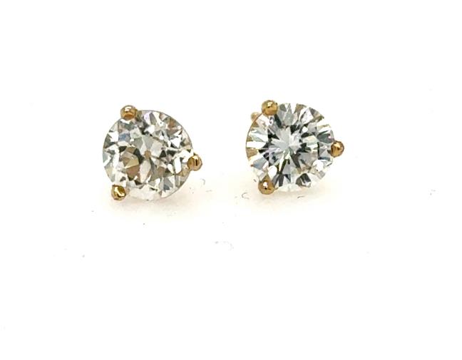Round diamond stud earrings in 14K yellow gold three-prong martini settings.
