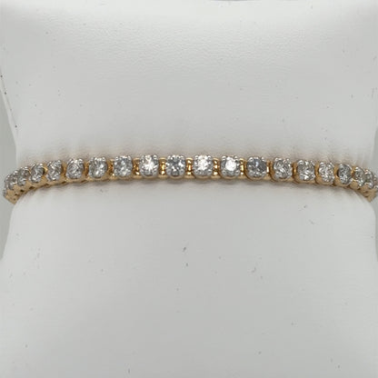 14K yellow gold tennis bracelet with round diamonds in four-prong settings.