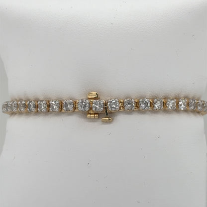 14K yellow gold tennis bracelet with round diamonds in four-prong settings, hidden clasp.