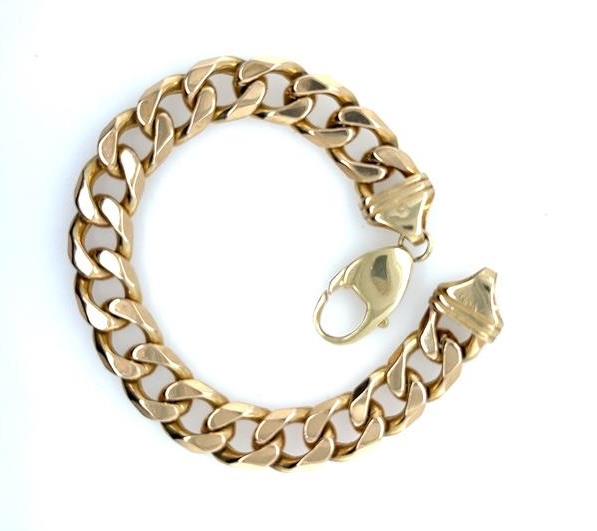 Yellow gold curb link bracelet with wide links and a heavy lobster clasp.