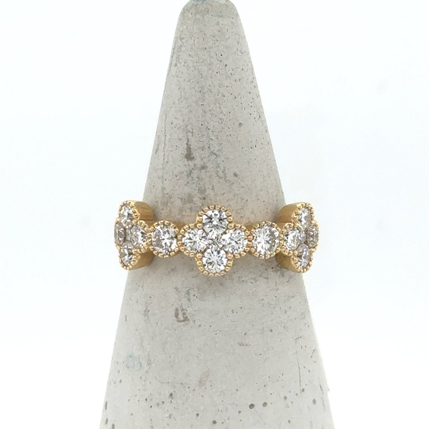 14K yellow gold band with diamond clover motifs and round diamond accents.