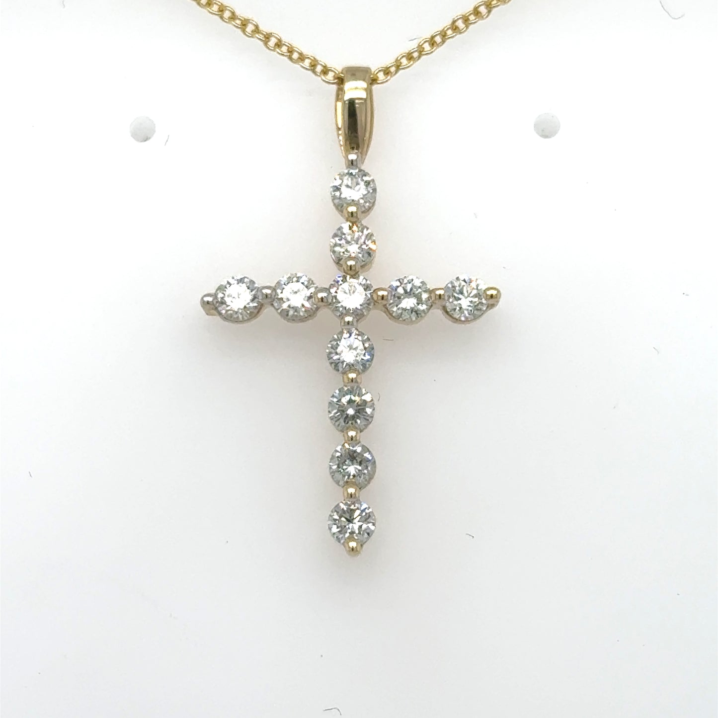 14K yellow gold cross pendant with round diamonds and a plain bail.