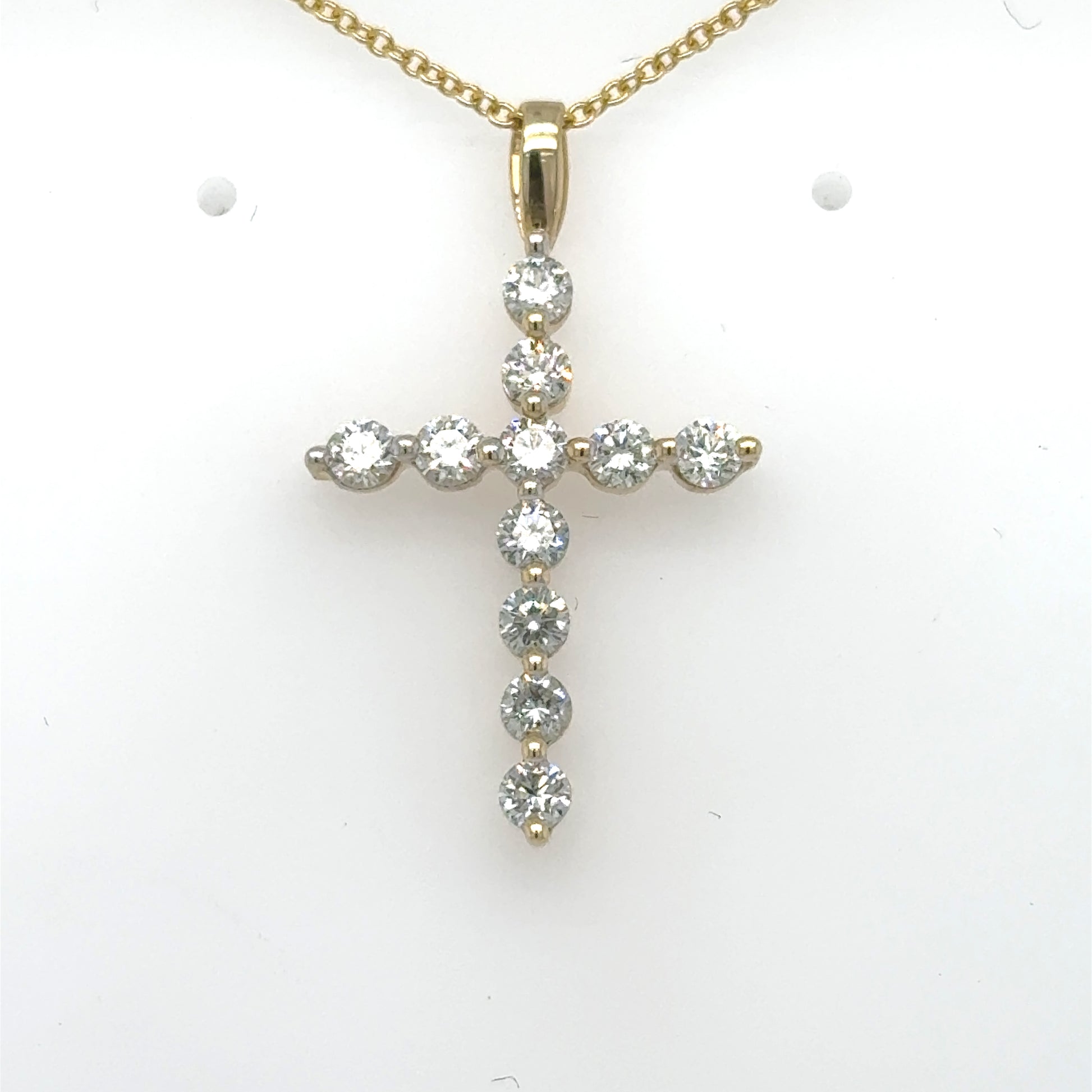 14K yellow gold cross pendant with round diamonds and a plain bail.