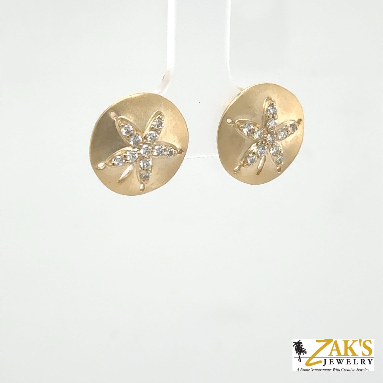14K yellow gold sand dollar stud earrings with diamond-accented starburst centers.