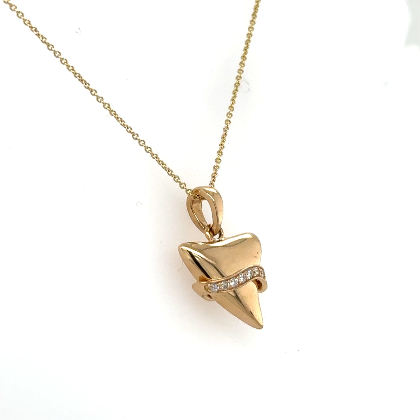 14K yellow gold shark tooth pendant with diamond-accent band on cable chain.