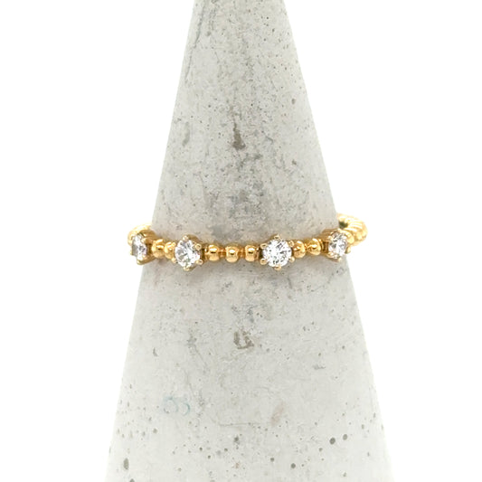 18K yellow gold beaded band with spaced round white diamond accents.