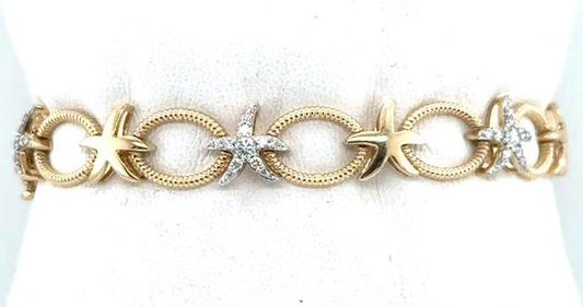 14K yellow gold bracelet with textured oval links and diamond-accent starfish motifs.
