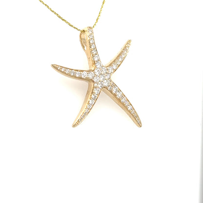 14K yellow gold starfish pendant with pavé round diamonds and hidden bail.