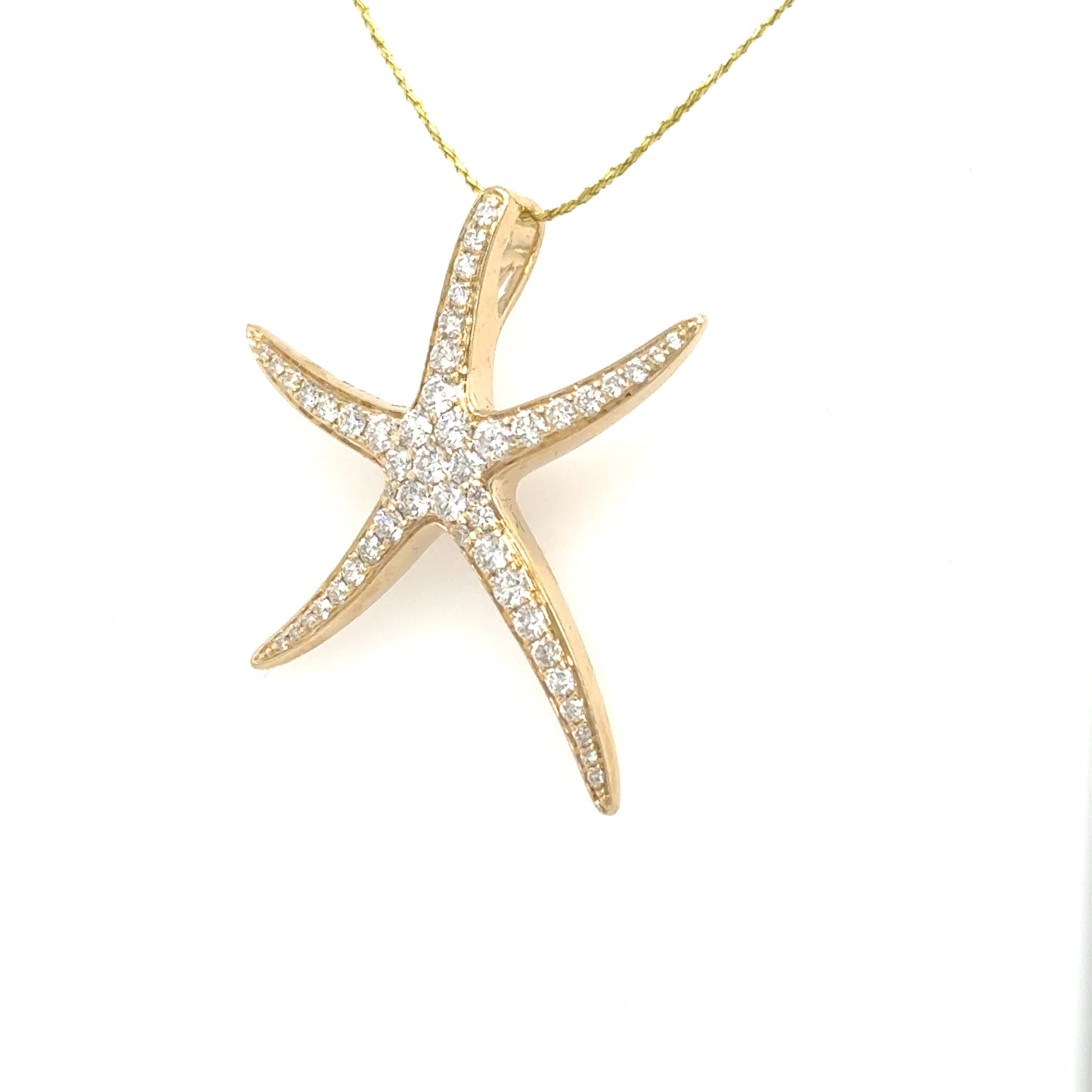 14K yellow gold starfish pendant with pavé round diamonds and hidden bail.