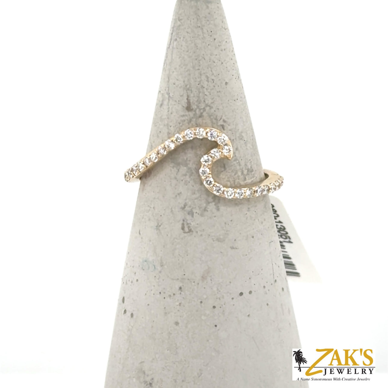 14K yellow gold wave ring with round diamonds in a pavé-like shared-prong band.