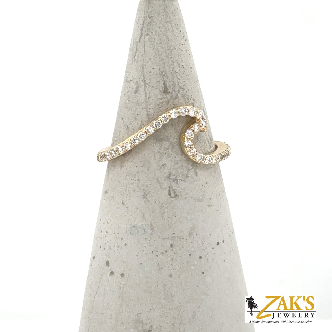 14K yellow gold wave ring with shared-prong round diamond pavé band.