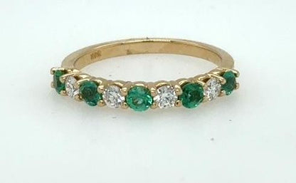 14K yellow gold band with alternating round emeralds and diamonds in shared prongs.