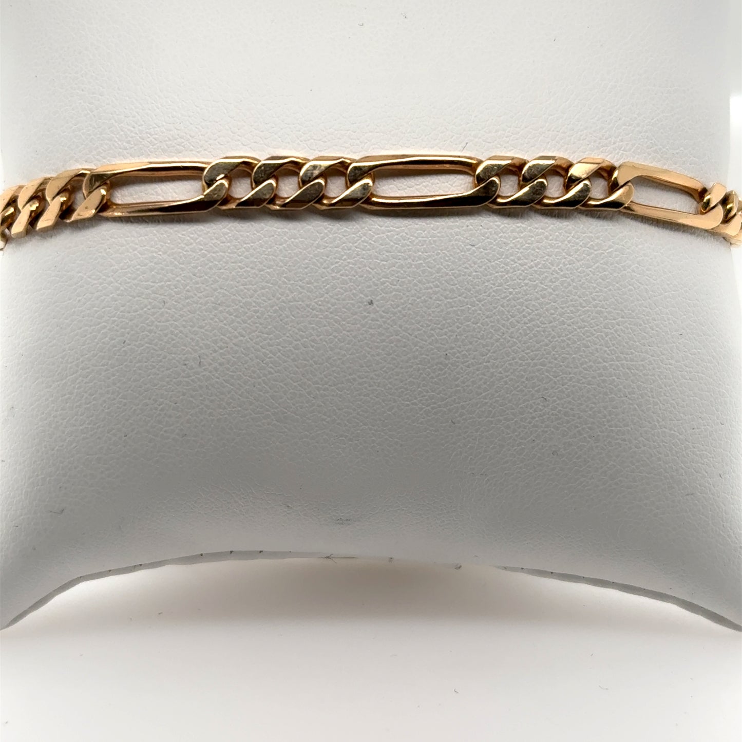 14K yellow gold Figaro chain bracelet with alternating long and short links.