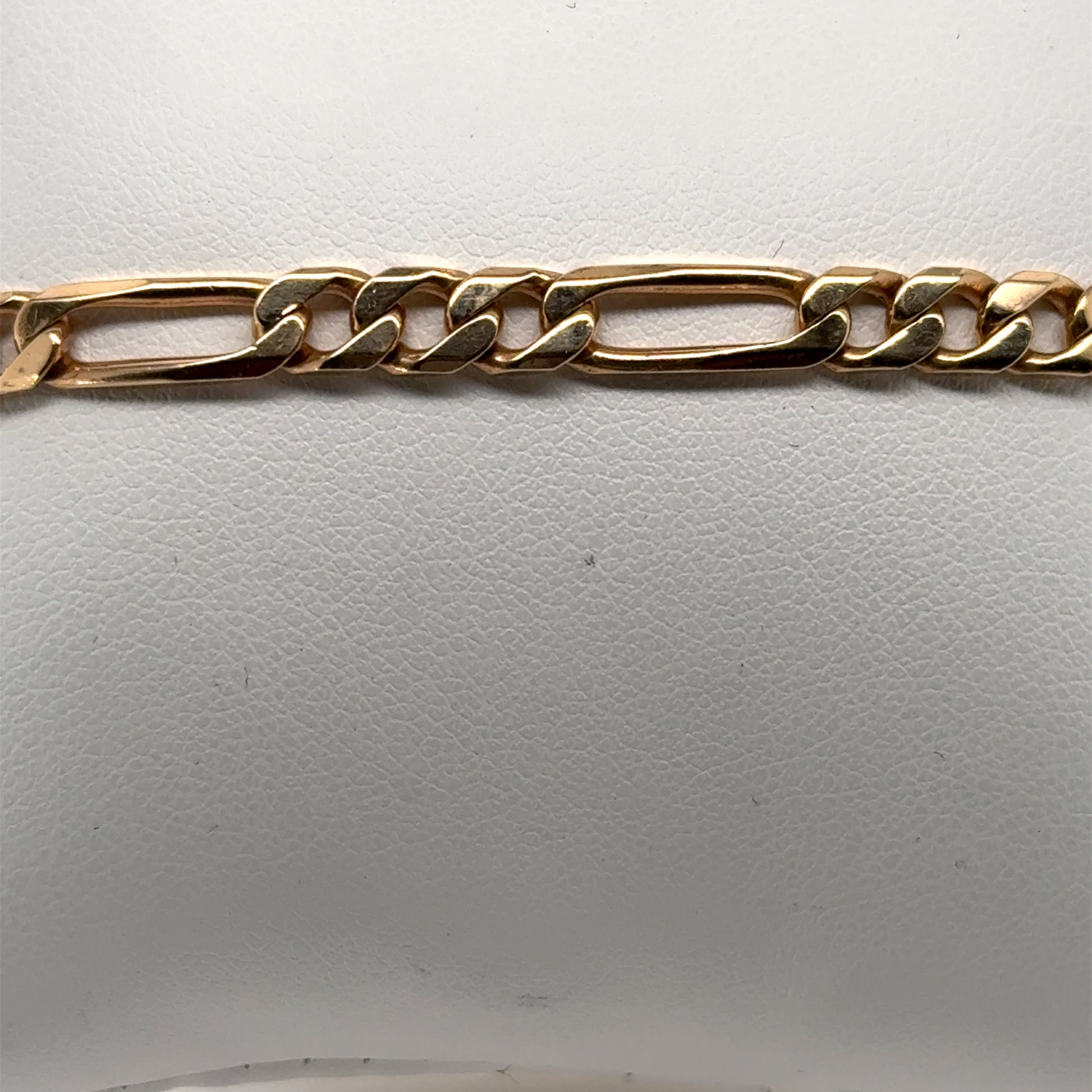 14K yellow gold Figaro bracelet with alternating elongated and curb links.