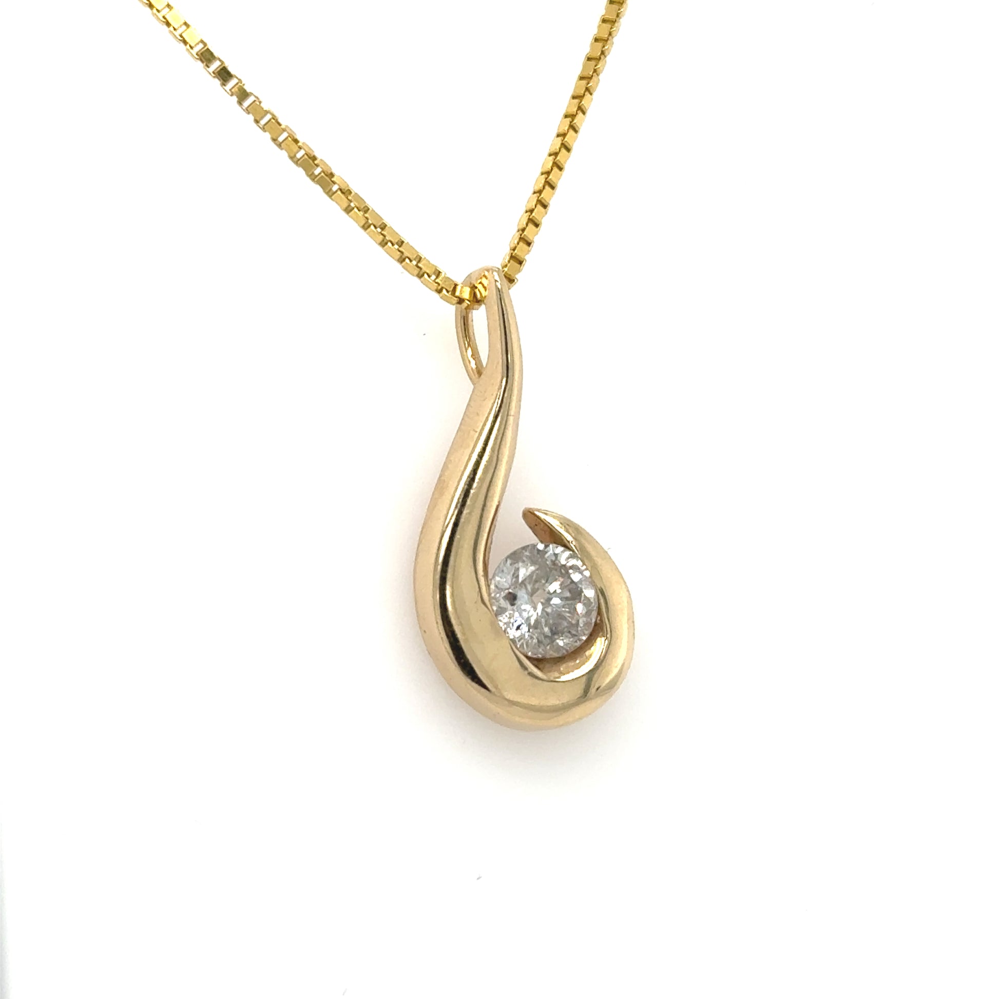Yellow gold freeform pendant with round diamond in half-bezel, on box chain.