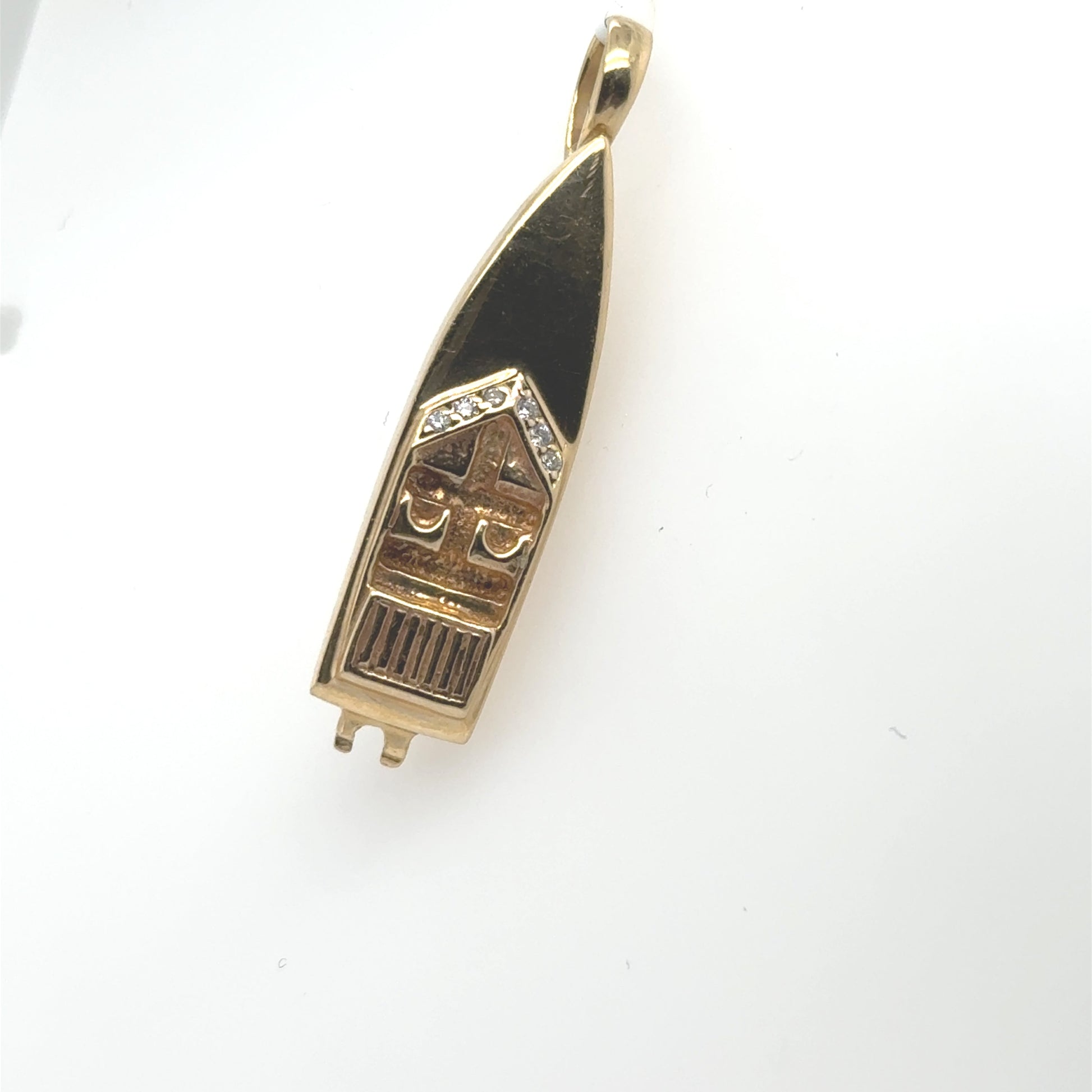 14K yellow gold speedboat pendant with black enamel details and diamond accents.