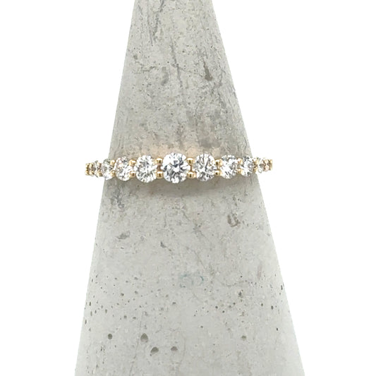 14K yellow gold band with graduated round diamonds in shared-prong setting.