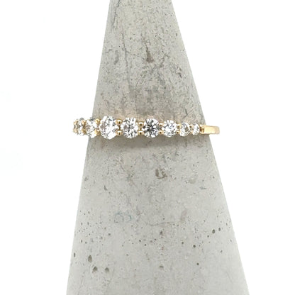 14K yellow gold band with graduated round diamonds in shared-prong setting.