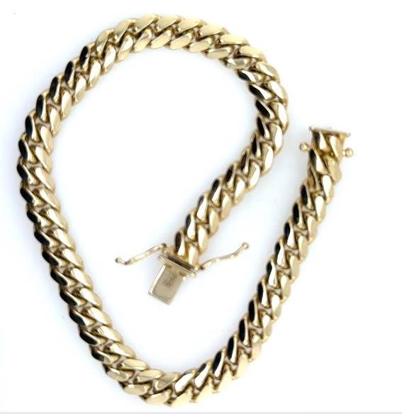 14K yellow gold Miami Cuban link bracelet with box clasp and safety locks.