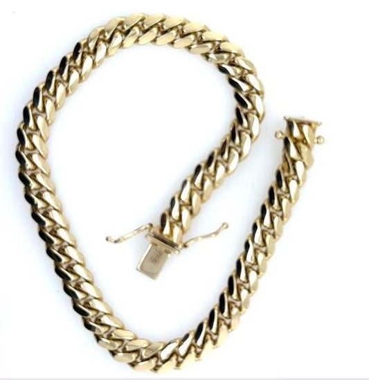 14K yellow gold Miami Cuban link bracelet with box clasp and safety locks.