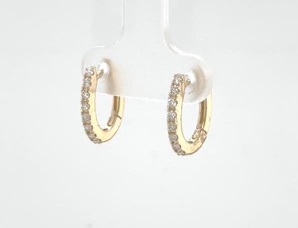 14K yellow gold oval huggie earrings with prong-set round diamonds on front.