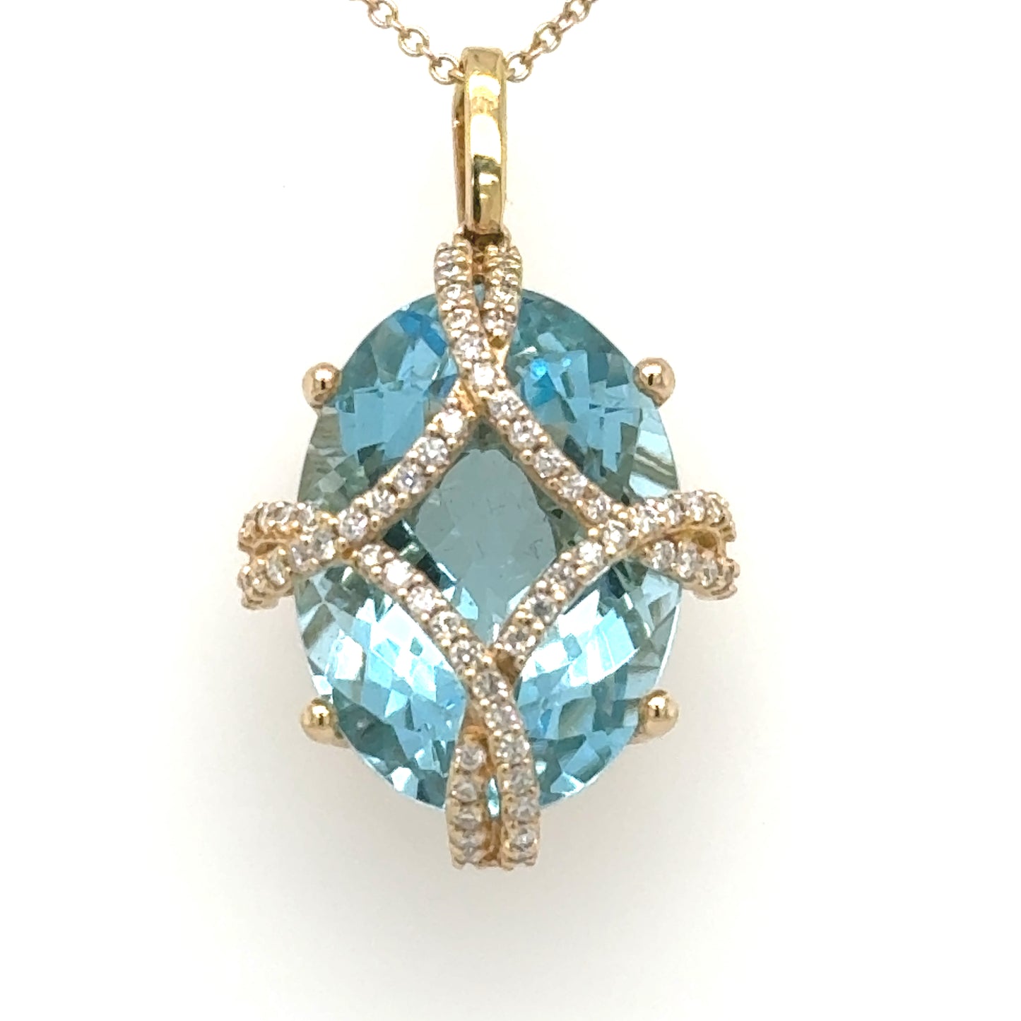 Oval Swiss blue topaz pendant with diamond pavé crisscross in yellow gold.