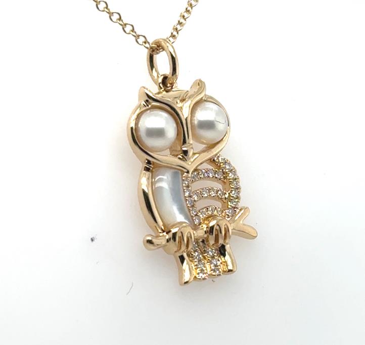 14K yellow gold owl pendant with pearl eyes, mother-of-pearl and diamond accents.