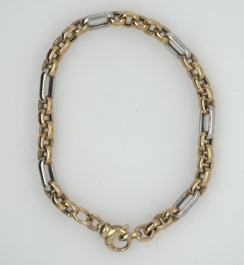 14K yellow and white gold Figaro-style cable bracelet with lobster clasp.