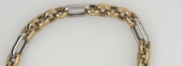 14K yellow and white gold bracelet with cable Figaro links and elongated separators.
