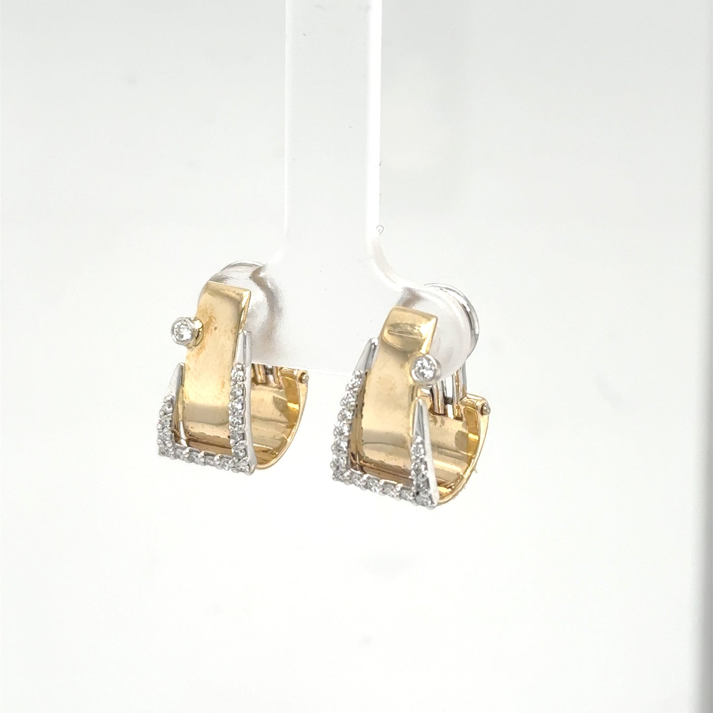 Yellow and white gold buckle hoop earrings with pavé diamonds and bezel accents.
