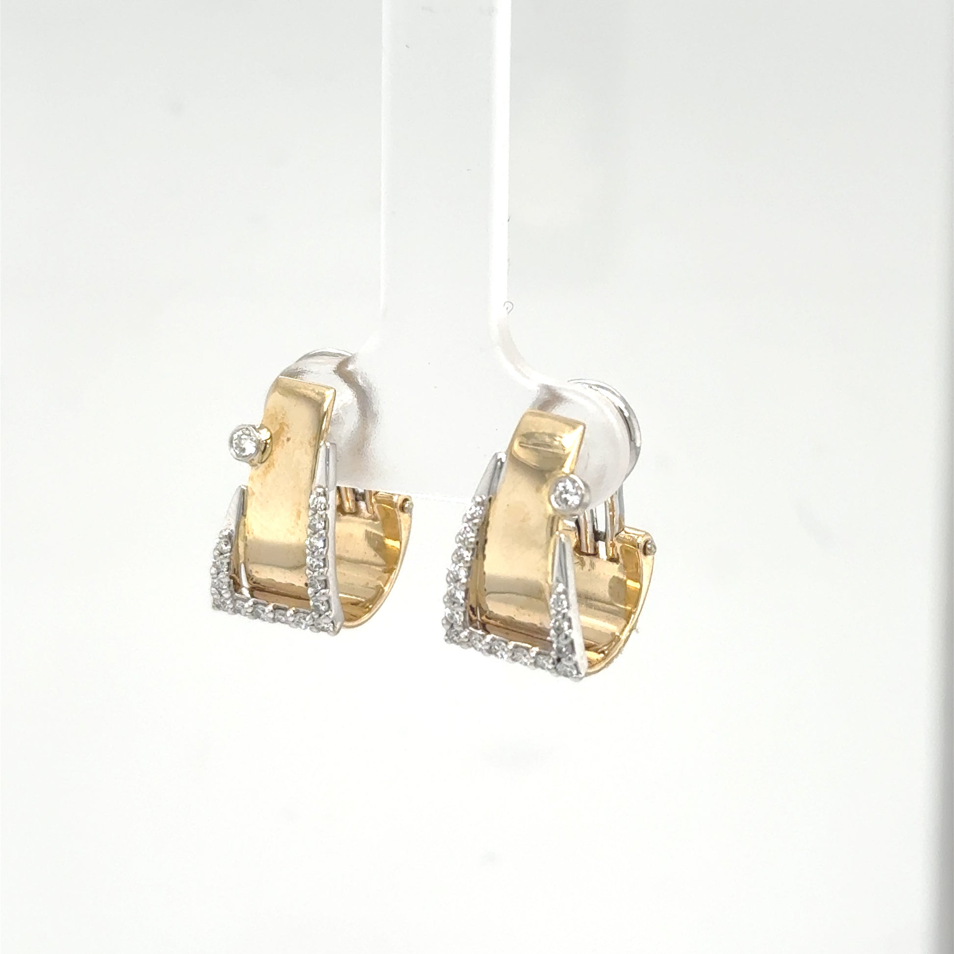 Yellow and white gold buckle hoop earrings with pavé diamonds and bezel accents.