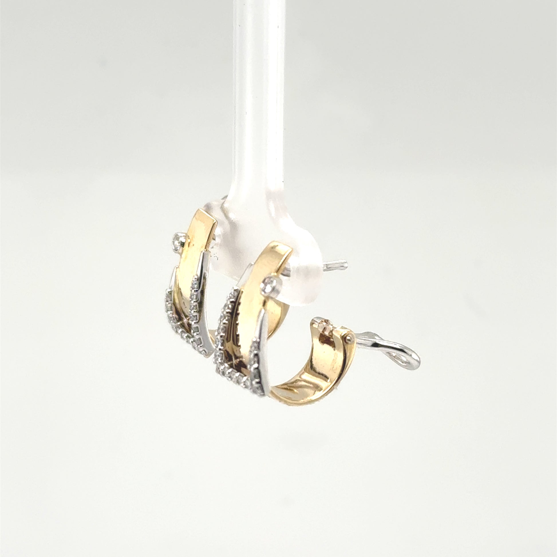 14K yellow and white gold buckle hoop earrings with diamond accents and omega backs.