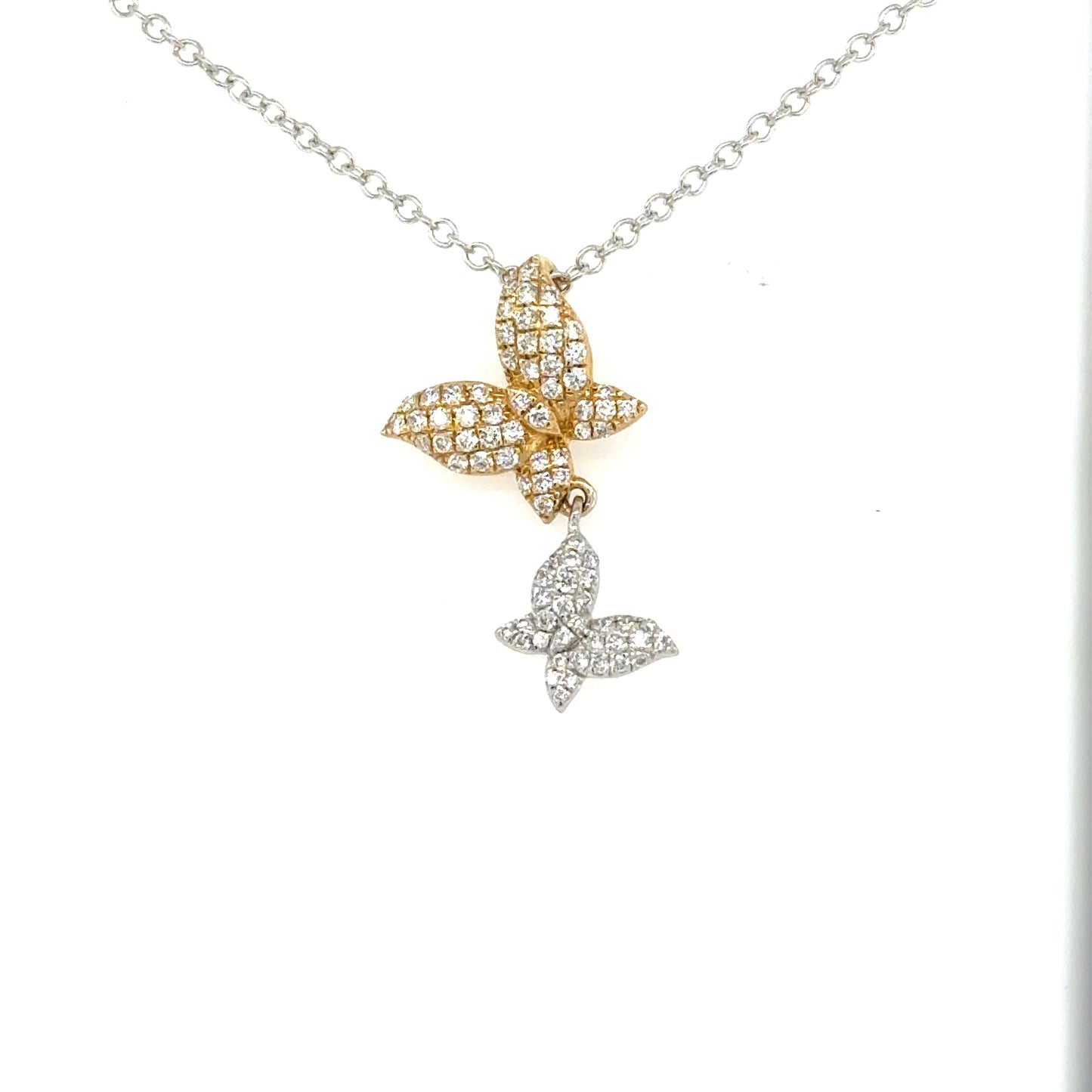 Two diamond-pavé butterfly pendants in yellow and white gold on a white gold chain.