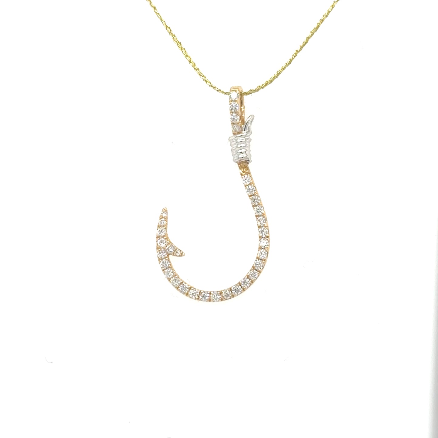 Yellow and white gold fish hook pendant pavé-set with round diamonds.